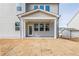 Rear of home with a covered porch and freshly seeded lawn in the backyard at 735 Crossroad Sw Ct, Powder Springs, GA 30127