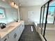 Bright bathroom with double sinks, modern vanity, soaking tub, and glass enclosed shower at 735 Crossroad Sw Ct, Powder Springs, GA 30127
