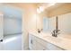 Bright bathroom featuring a double vanity, white cabinets and a large mirror at 735 Crossroad Sw Ct, Powder Springs, GA 30127