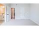 Neutral bedroom showcasing a doorway to the bathroom, light carpet and white walls at 735 Crossroad Sw Ct, Powder Springs, GA 30127