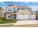 Charming two-story home featuring a three-car garage, brick accents, and a well-manicured lawn at 735 Crossroad Sw Ct, Powder Springs, GA 30127