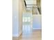 Bright two-story foyer showcasing hardwood floors and an elegant staircase leading to the second floor at 735 Crossroad Sw Ct, Powder Springs, GA 30127