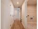 Hallway with visible laundry room and wood flooring at 735 Crossroad Sw Ct, Powder Springs, GA 30127