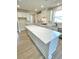 A modern kitchen with white cabinets, an island with countertop, and stainless steel appliances at 735 Crossroad Sw Ct, Powder Springs, GA 30127