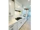 Modern kitchen with white cabinets, quartz countertops, stainless steel appliances, and a subway tile backsplash at 735 Crossroad Sw Ct, Powder Springs, GA 30127