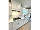 Contemporary kitchen featuring quartz countertops, white cabinets, stainless steel appliances, and recessed lighting at 735 Crossroad Sw Ct, Powder Springs, GA 30127