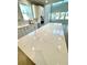 Bright kitchen features white cabinets, stainless appliances, and a spacious island with marble countertop at 735 Crossroad Sw Ct, Powder Springs, GA 30127