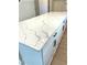 Close-up shot of a large kitchen island with white cabinets and a countertop with marble pattern at 735 Crossroad Sw Ct, Powder Springs, GA 30127