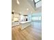 Spacious kitchen with white cabinets, stainless steel appliances, and a central island overlooking the living area at 735 Crossroad Sw Ct, Powder Springs, GA 30127