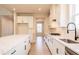 Open concept kitchen featuring an island with quartz countertop, white cabinets, and stainless steel appliances at 735 Crossroad Sw Ct, Powder Springs, GA 30127