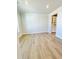 Spacious living room featuring hardwood floors and natural light from a large window at 735 Crossroad Sw Ct, Powder Springs, GA 30127