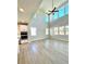 Bright open-concept living room with tall ceilings and large windows, seamlessly connected to the kitchen at 735 Crossroad Sw Ct, Powder Springs, GA 30127