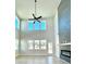 Living room featuring high ceilings, large windows, and a modern fireplace with a striking gray stone accent wall at 735 Crossroad Sw Ct, Powder Springs, GA 30127