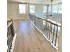 A view of the loft area featuring hardwood floors and natural light from multiple windows at 735 Crossroad Sw Ct, Powder Springs, GA 30127