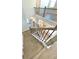 A view down the staircase to the open-concept living space and white kitchen at 735 Crossroad Sw Ct, Powder Springs, GA 30127