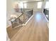 Staircase with hardwood steps, neutral paint, and black metal railing, leading to the upper level at 735 Crossroad Sw Ct, Powder Springs, GA 30127