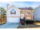 Two-story house with stone and siding accents, attached garage, and steps leading to the front entrance at 4118 Lost Springs Trl, Douglasville, GA 30135