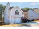 Two-story house with stone and siding accents, attached garage, and steps leading to the front entrance at 4118 Lost Springs Trl, Douglasville, GA 30135