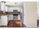 Kitchen with white cabinets, stainless steel appliances, and mosaic backsplash at 4118 Lost Springs Trl, Douglasville, GA 30135