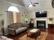 Spacious living room with hardwood floors, fireplace, and large windows at 4118 Lost Springs Trl, Douglasville, GA 30135