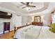 Main bedroom features wood floors, trey ceiling with fan and dresser with mirror at 1040 Avery Creek Dr, Woodstock, GA 30188