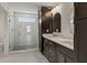 Modern bathroom features a glass-enclosed shower with marble tile and a dual sink vanity with dark cabinets at 38 Puckett Se Rd, Emerson, GA 30137