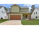 View of the home's exterior featuring a spacious garage with a light green exterior and a well-maintained lawn at 38 Puckett Se Rd, Emerson, GA 30137