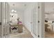 Chic home office with french doors, decorative wall paneling and view into dining nook and kitchen at 38 Puckett Se Rd, Emerson, GA 30137