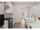 Modern kitchen with quartz countertops, stainless steel appliances, and a stylish backsplash at 38 Puckett Se Rd, Emerson, GA 30137