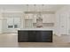 Modern kitchen with a large dark island, white cabinets, stainless steel appliances, and pendant lighting at 38 Puckett Se Rd, Emerson, GA 30137