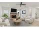 Cozy living room with a fireplace, ceiling fan, comfortable seating, and natural light at 38 Puckett Se Rd, Emerson, GA 30137