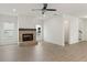 Bright, spacious living room with a brick fireplace, ceiling fan, and luxury vinyl plank flooring at 38 Puckett Se Rd, Emerson, GA 30137