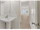 Elegant powder room with a pedestal sink and view into dining area at 38 Puckett Se Rd, Emerson, GA 30137
