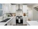 Modern kitchen boasts stainless steel appliances, white cabinets and countertops, and sleek hardware at 1270 Graymont Sw Dr, Atlanta, GA 30310