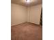 Simple bedroom featuring neutral walls and carpeted floors, with dark curtains partially visible at 424 Village Way, Loganville, GA 30052