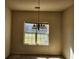 Dining area featuring a simple chandelier and a window for natural light at 424 Village Way, Loganville, GA 30052