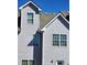Exterior view of home showcasing light gray siding, double hung windows and architectural details at 424 Village Way, Loganville, GA 30052