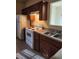 Functional kitchen with an electric range oven and dark wood cabinetry at 424 Village Way, Loganville, GA 30052