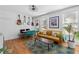 Living area featuring hardwood floors, mustard-colored sofa, and guitar wall decor at 764 Edgewood Ne Ave # 1, Atlanta, GA 30307