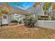 Landscaped backyard with mature bushes and flower bed. A white picket fence is also visible at 36 Latimer Nw Ln, Cartersville, GA 30121