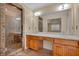 Elegant bathroom with a stone-enclosed glass shower and dual sinks set into the wood vanity at 36 Latimer Nw Ln, Cartersville, GA 30121