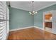 Charming dining room with hardwood floors, elegant chandelier, and a glimpse into the nearby kitchen at 36 Latimer Nw Ln, Cartersville, GA 30121