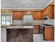 An open kitchen features wooden cabinets, stainless appliances, and granite countertops at 36 Latimer Nw Ln, Cartersville, GA 30121