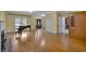 Open living room with wood floors, fireplace, piano, and access to kitchen and entry at 36 Latimer Nw Ln, Cartersville, GA 30121