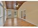 Well-lit sunroom featuring wood floors, vaulted ceilings, and multiple windows with shutter blinds at 36 Latimer Nw Ln, Cartersville, GA 30121