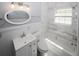 Updated bathroom with marble tile, white vanity, and bathtub at 1110 Mcdaniel Sw St, Atlanta, GA 30310