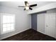 Bedroom with dark hardwood floors, ceiling fan and barn door at 1110 Mcdaniel Sw St, Atlanta, GA 30310