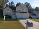Traditional two-story home with a two-car garage, neutral siding, and a well-manicured front lawn at 6579 Alford Way, Lithonia, GA 30058