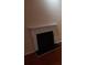 A white fireplace with black metal screen and hearth located in the living room at 6579 Alford Way, Lithonia, GA 30058