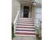 Close-up of the front door with steps leading up to the entrance, featuring white railing at 6579 Alford Way, Lithonia, GA 30058